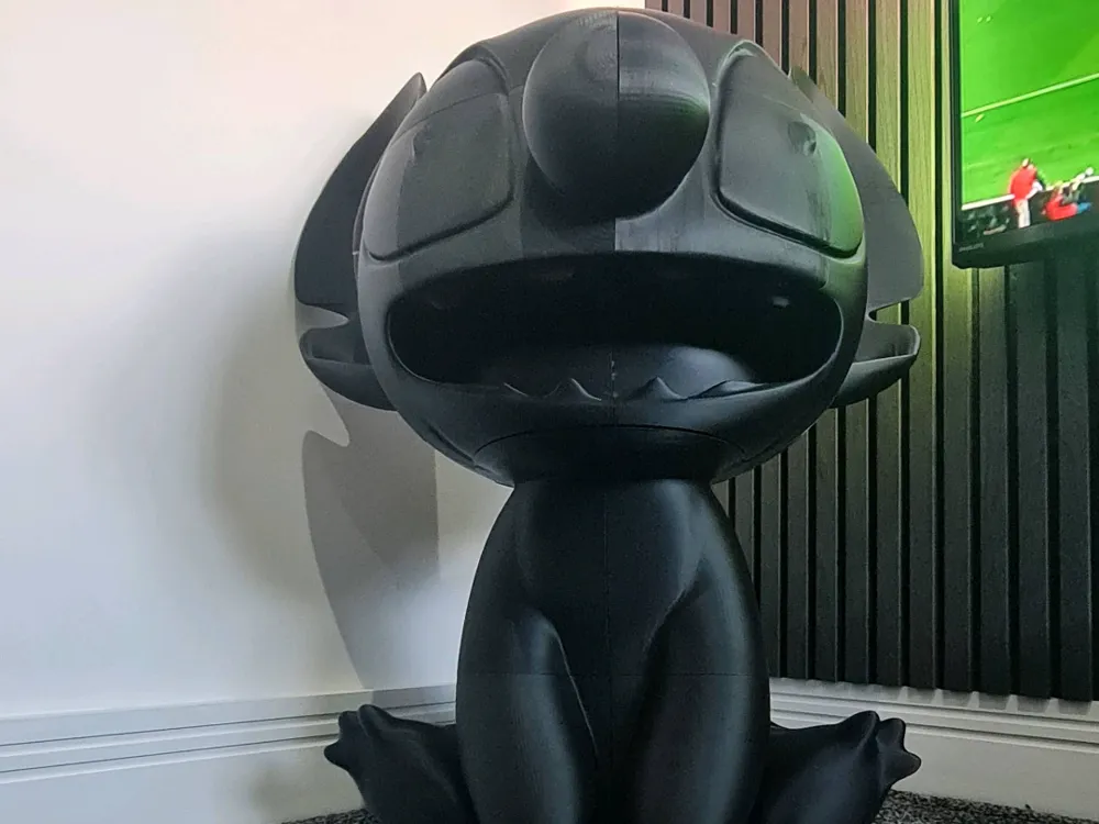 Large seated blue creature character assembled from printed sections